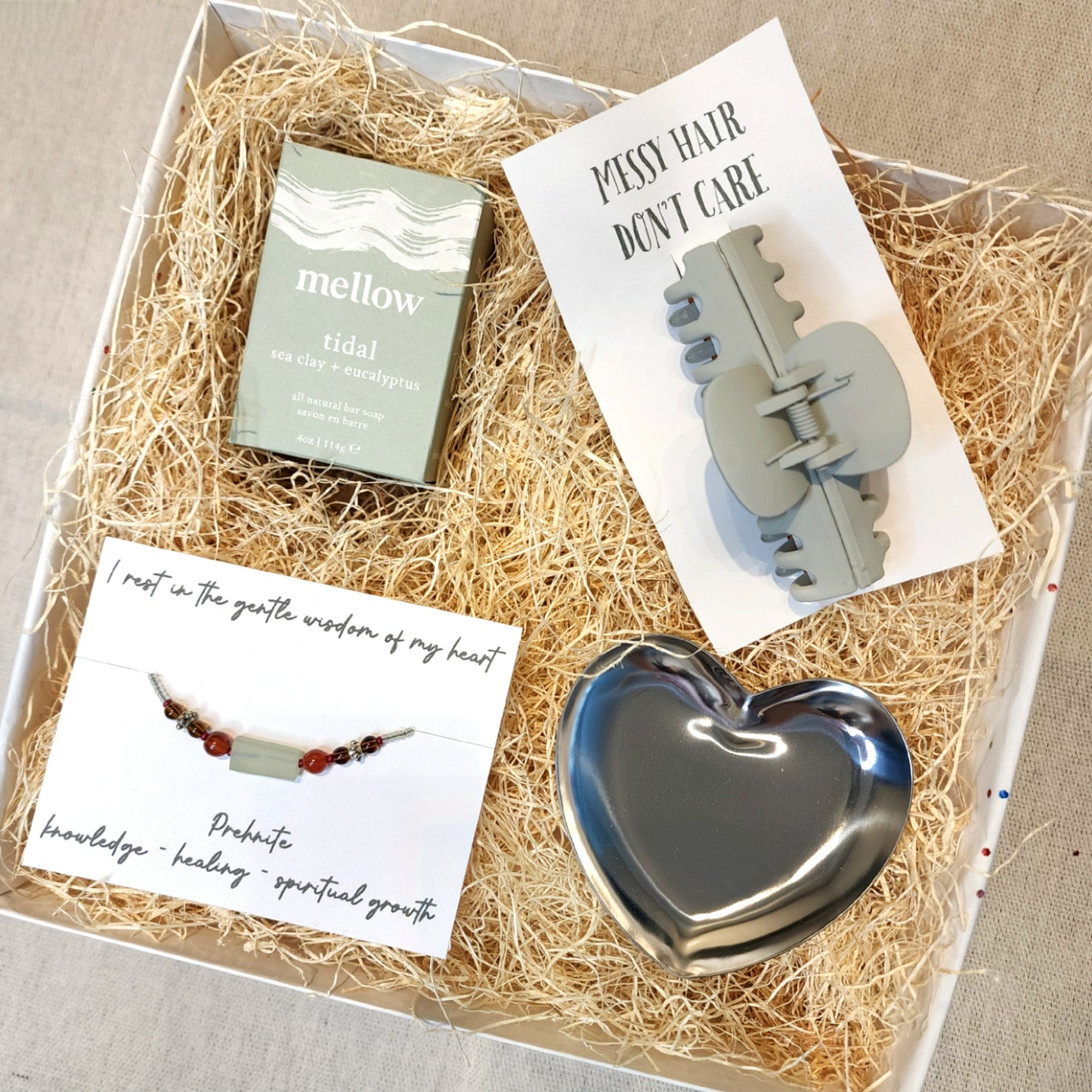 Gift box includes: - Tidal Sea Salt and Eucalyptus scented soap // Mellow - Prehnite Semi-Precious Gemstone Bracelet - Claw Clip - Heart Trinket Dish