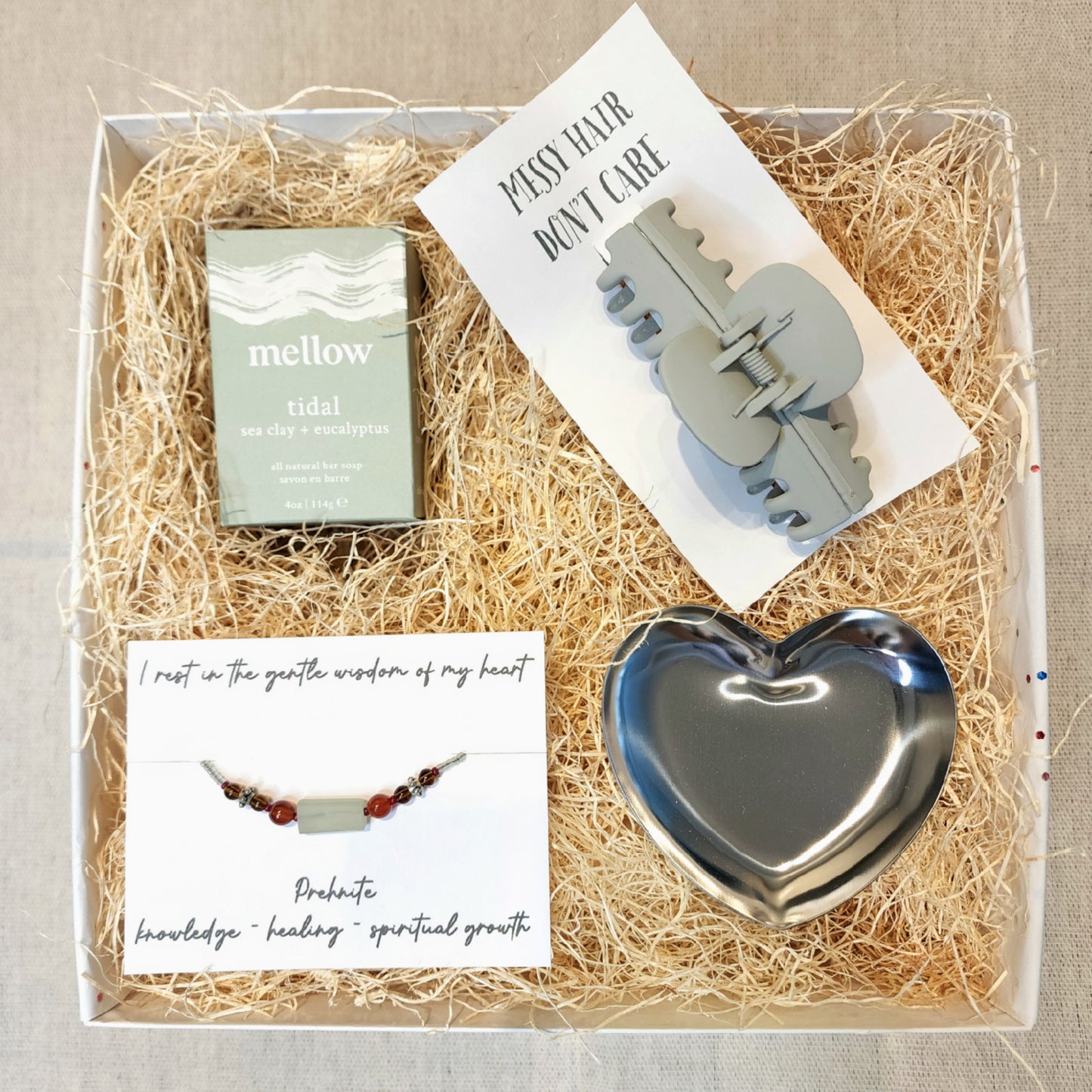 Gift box includes: - Tidal Sea Salt and Eucalyptus scented soap // Mellow - Prehnite Semi-Precious Gemstone Bracelet - Claw Clip - Heart Trinket Dish