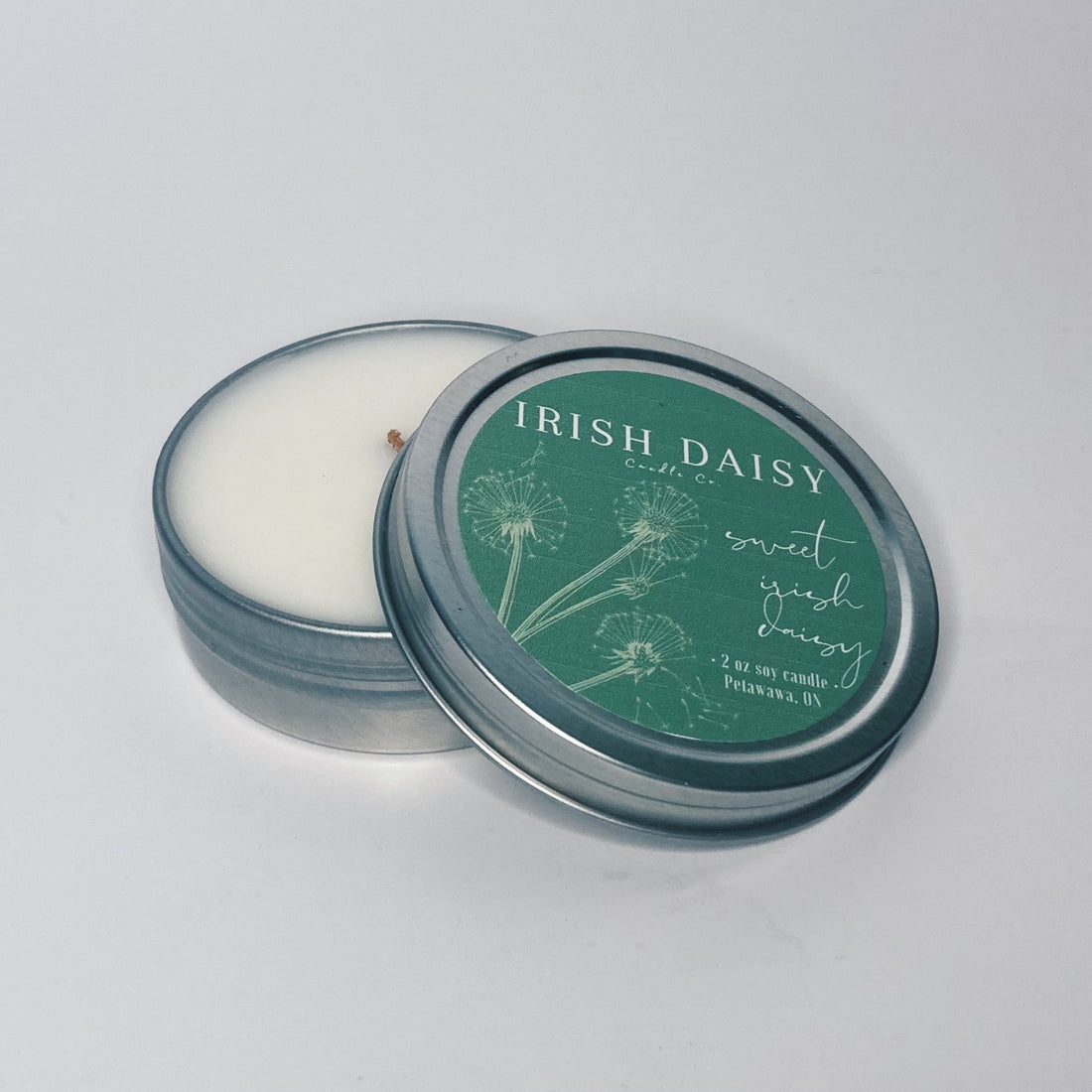 2 oz tin candle in sweet Irish Daisy scent.